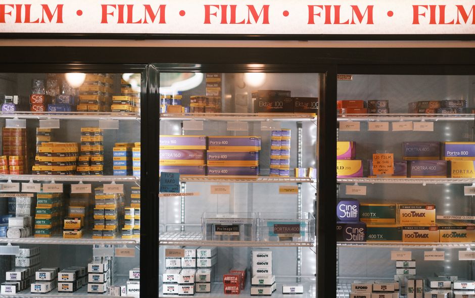 Photographic film stocked in a refrigerated display at a store.